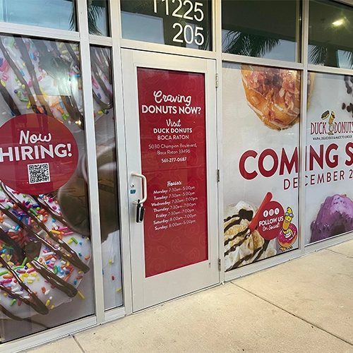 Duck Donuts storefront with custom window graphics and decals
