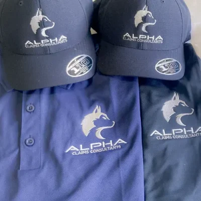 Custom embroidered navy hats and polos with Alpha Claims Consultants logo by Miami Epic Tees